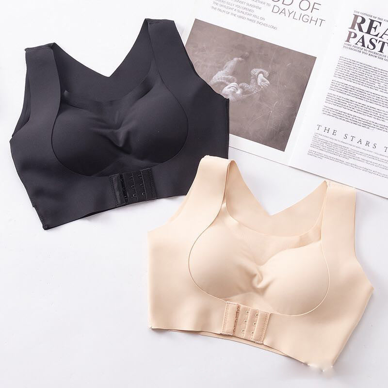 Black and beige bras on a white surface with a magazine in the background