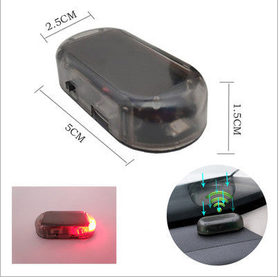 Red Compact simulated car alarm with adhesive mount on grille.