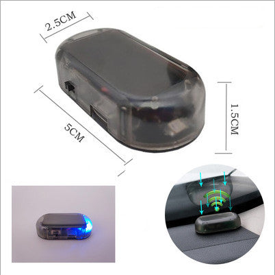 Blue Compact simulated car alarm with adhesive mount on grille.