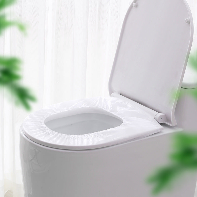 Toilet with waterproof non-woven travel seat cover installed