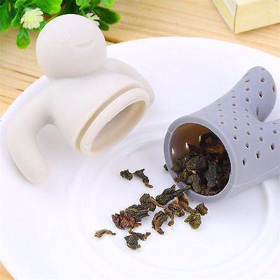 Tea infuser with loose tea leaves on a white surface