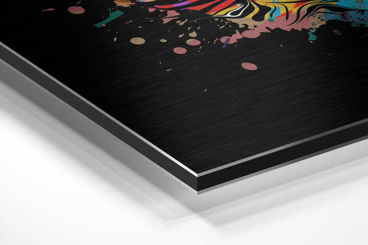 Colorful cat face brushed aluminum panel corner close-up showing the brushed metal grain