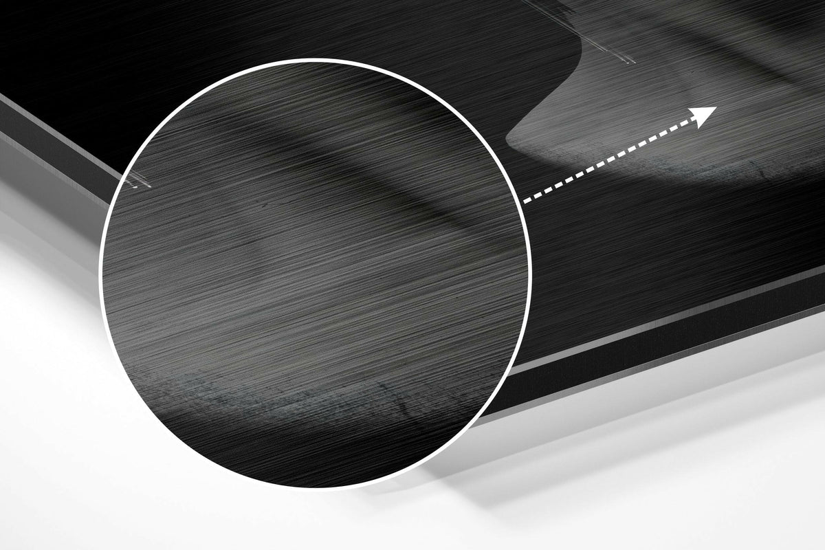 Magnified detail of the brushed metal grain showing through the gray glitched bust print