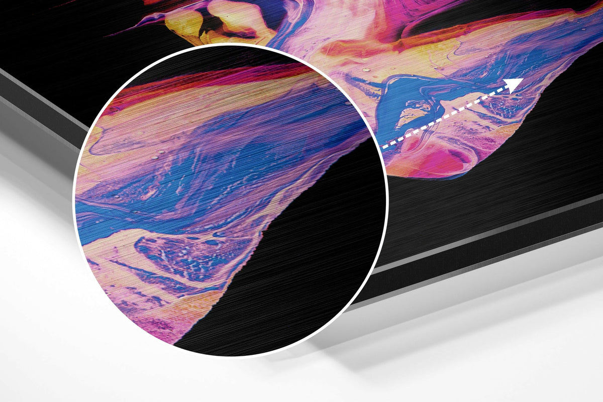 Magnified detail of the brushed metal grain showing through the pink and blue fluid paint print