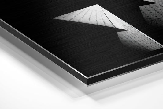 Black and white abstract architecture brushed aluminum panel corner close-up showing the brushed metal grain