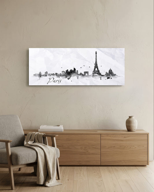 Paris ink skyline panoramic glass wall art above a light wood sideboard and beige armchair