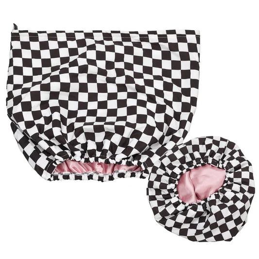 Black and white checkered waterproof shower cap with pink satin interior and elastic edge