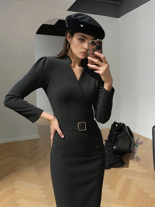Black belted midi dress captured indoors with a chic minimalist look