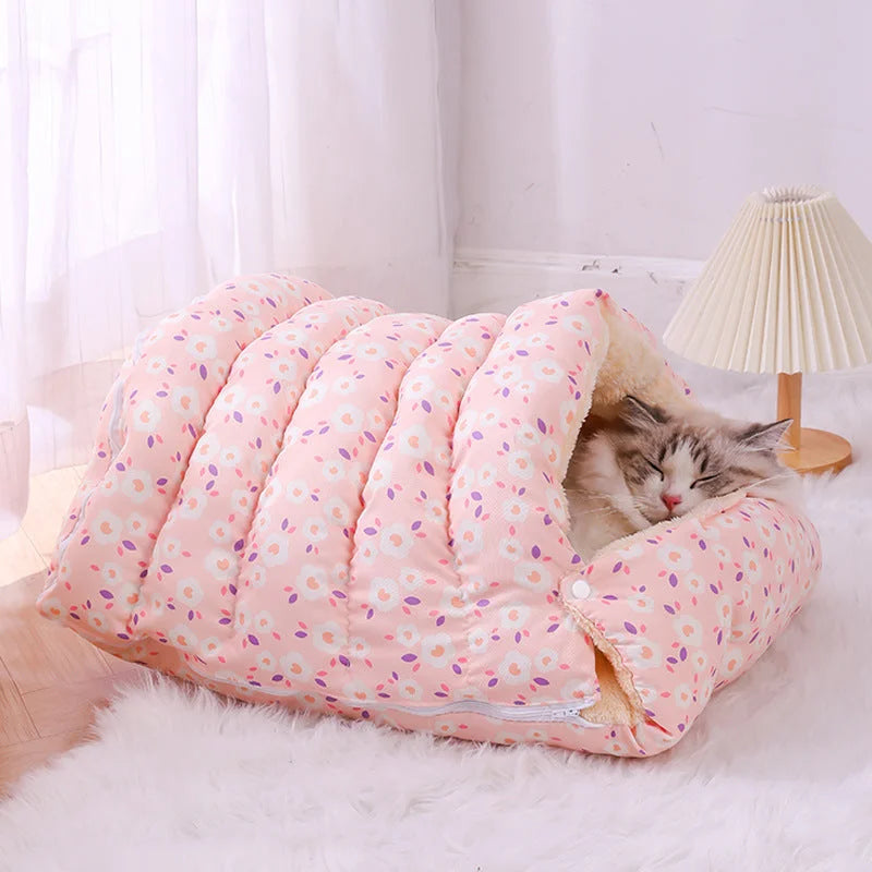 Cat sleeping inside pink spotted fleece-lined covered pet bed with soft cushioned interior and tunnel entrance