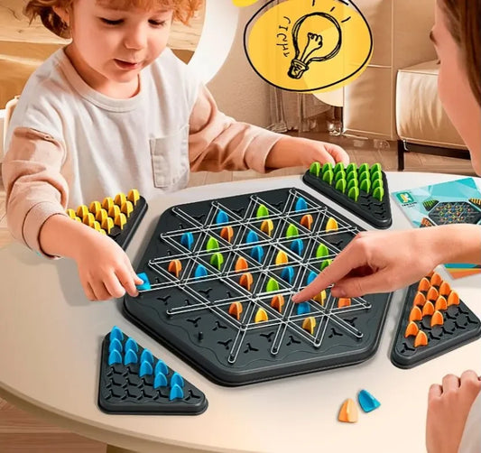 Children playing with a strategic board game on a table.