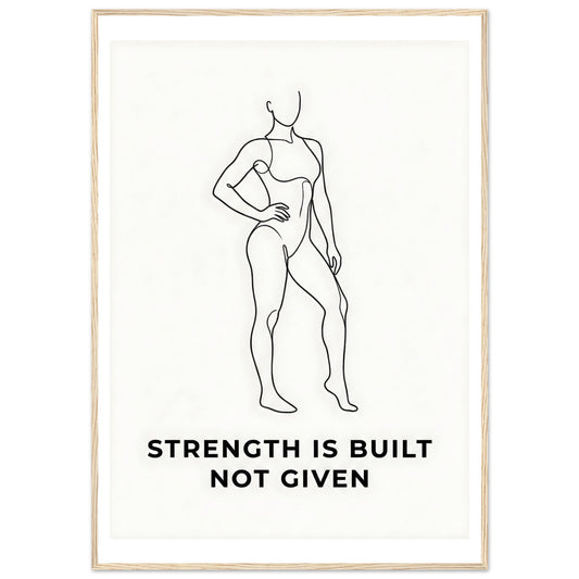 Framed poster with a black line drawing of a woman and the text 'Strength is built not given' on a white background.