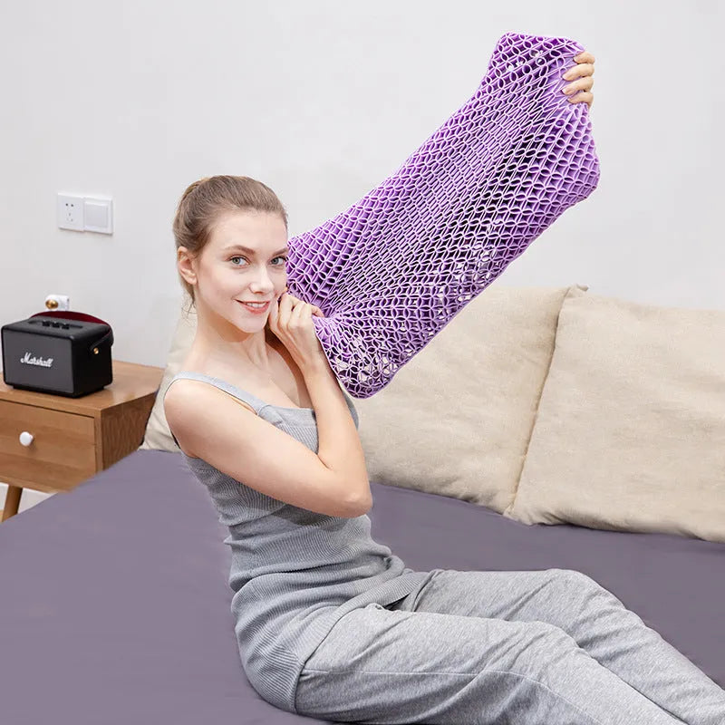 Gel cold pillow stretched by hand to demonstrate elastic and pressure-relieving honeycomb design in purple