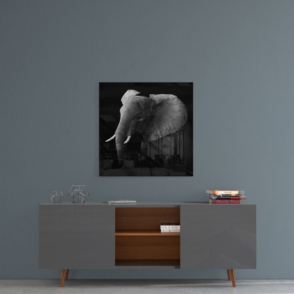 Black and white elephant glass wall art on a blue-gray wall above a gray sideboard with wood shelves