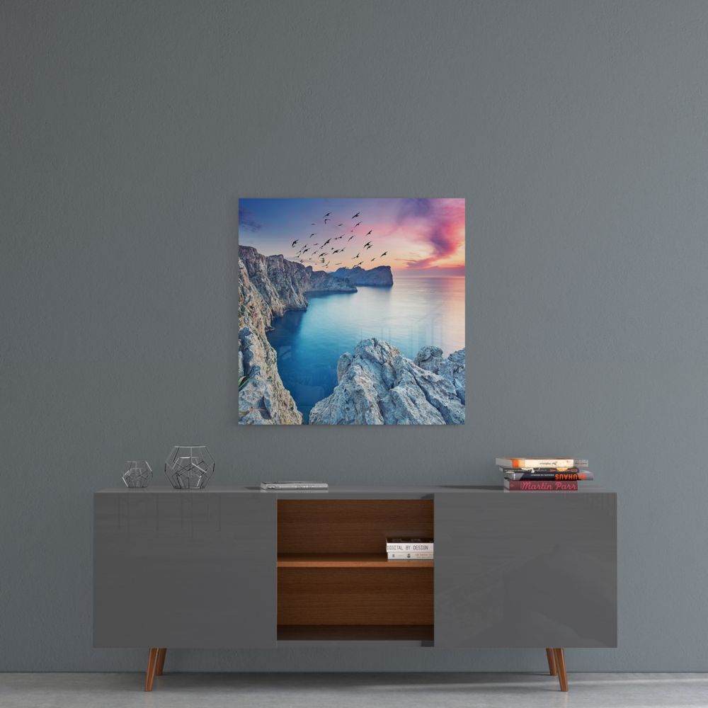 Sea cliffs square glass wall art on a gray wall above a gray sideboard