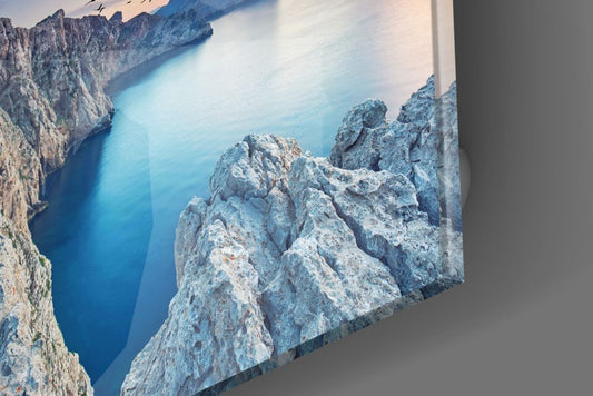 Close-up of the glossy tempered glass edge of the sea cliffs glass wall art