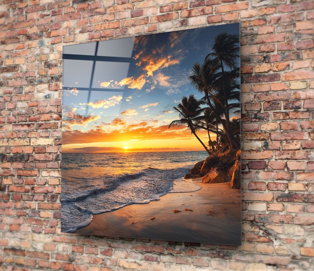 Palm tree cove sunset glass wall art hung on a red brick wall