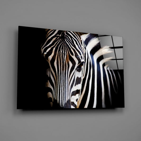 Zebra head on black glass wall art on a plain gray wall