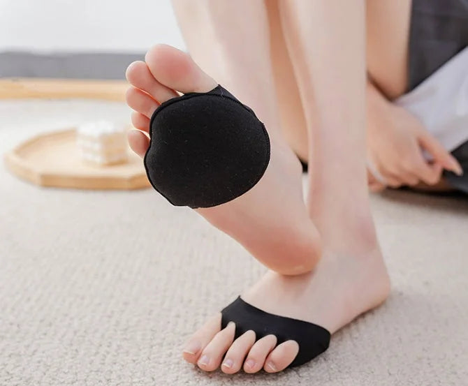 Person holding black forefoot pad sock showing breathable design for wearing with high heels