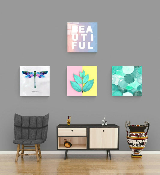 Pastel word, leaf, dragonfly and mint circle glass panels spaced on a gray wall above a dark wood sideboard