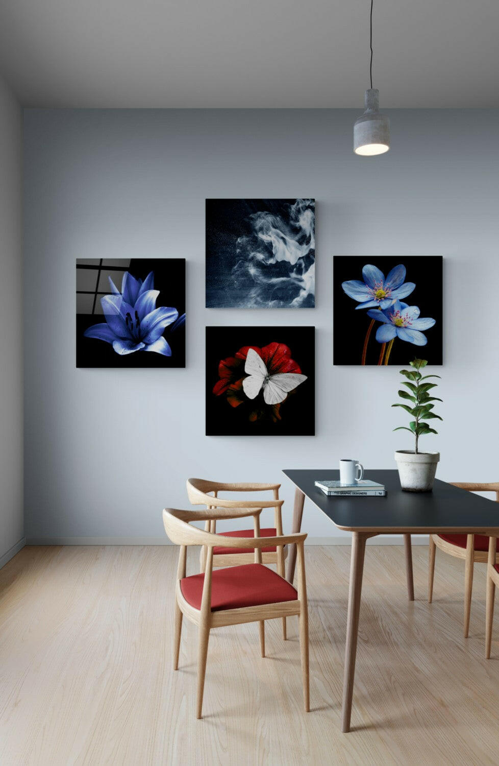 Moody floral glass panels in a loose cluster on a pale blue wall above a dark dining table