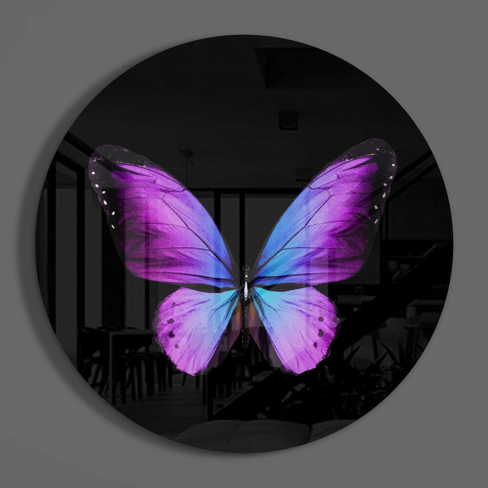 Purple butterfly round glass wall art hanging on a plain gray wall