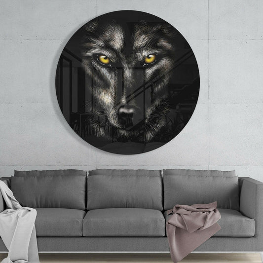 Yellow eyed wolf round glass wall art above a gray sofa with white and pink throws