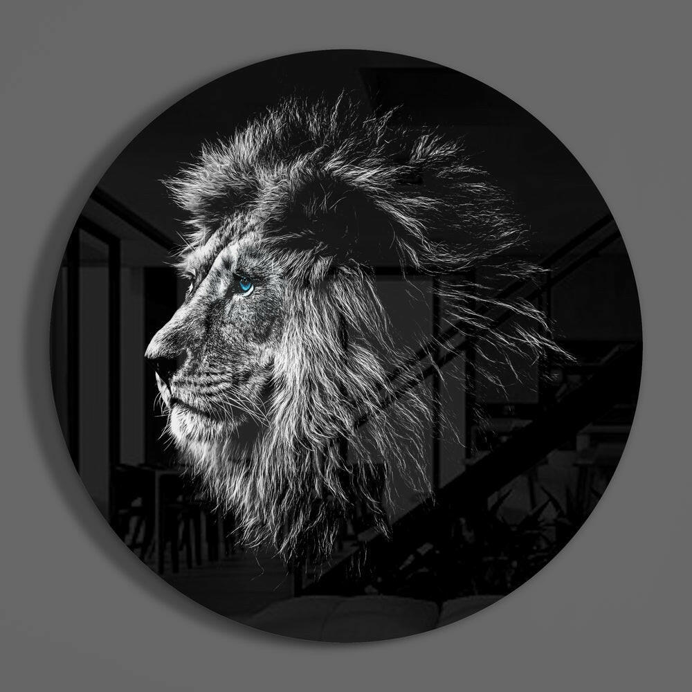 Blue eyed lion profile round glass wall art on a plain gray wall