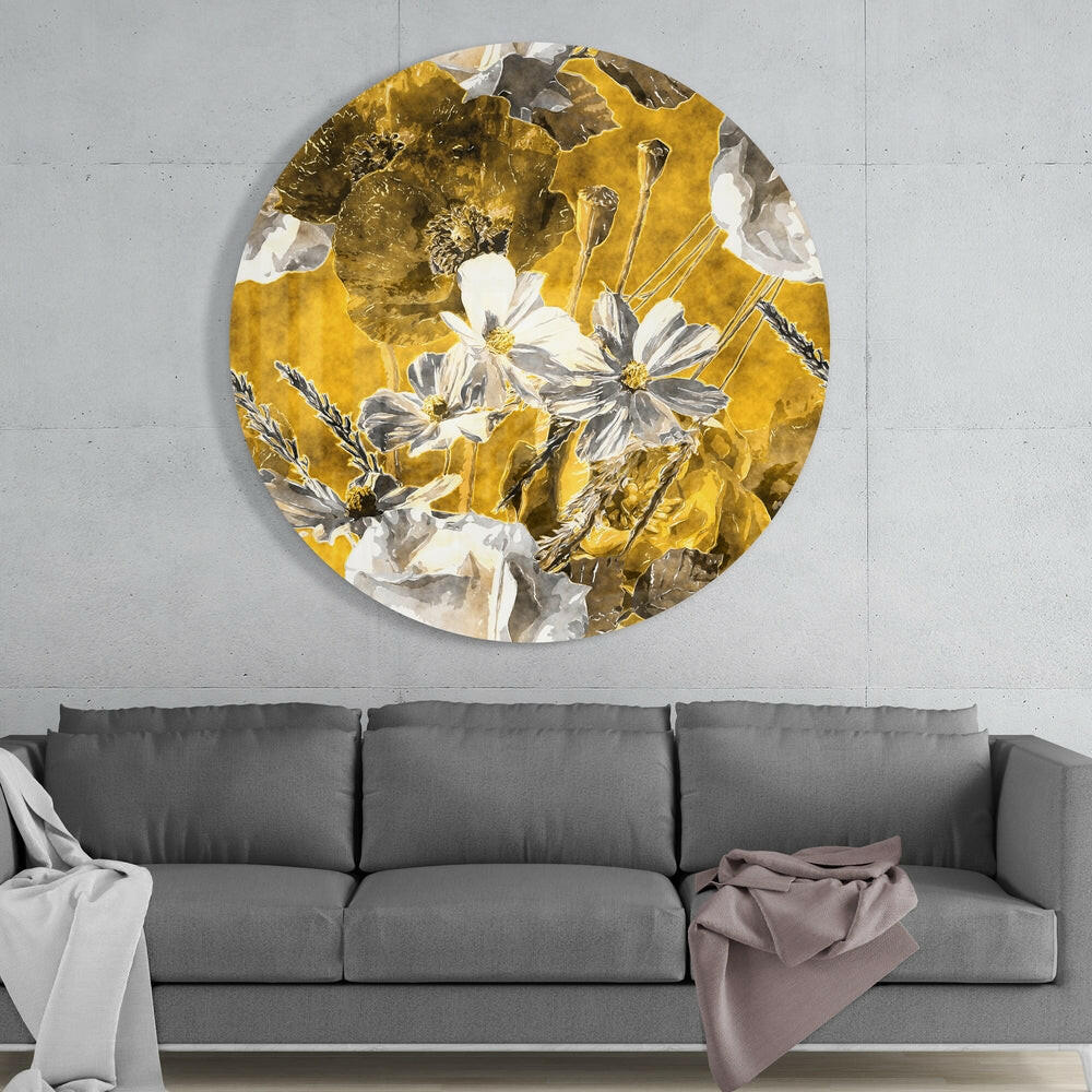 Mustard gold poppy field round glass wall art above a gray sofa with draped throws on a pale concrete wall