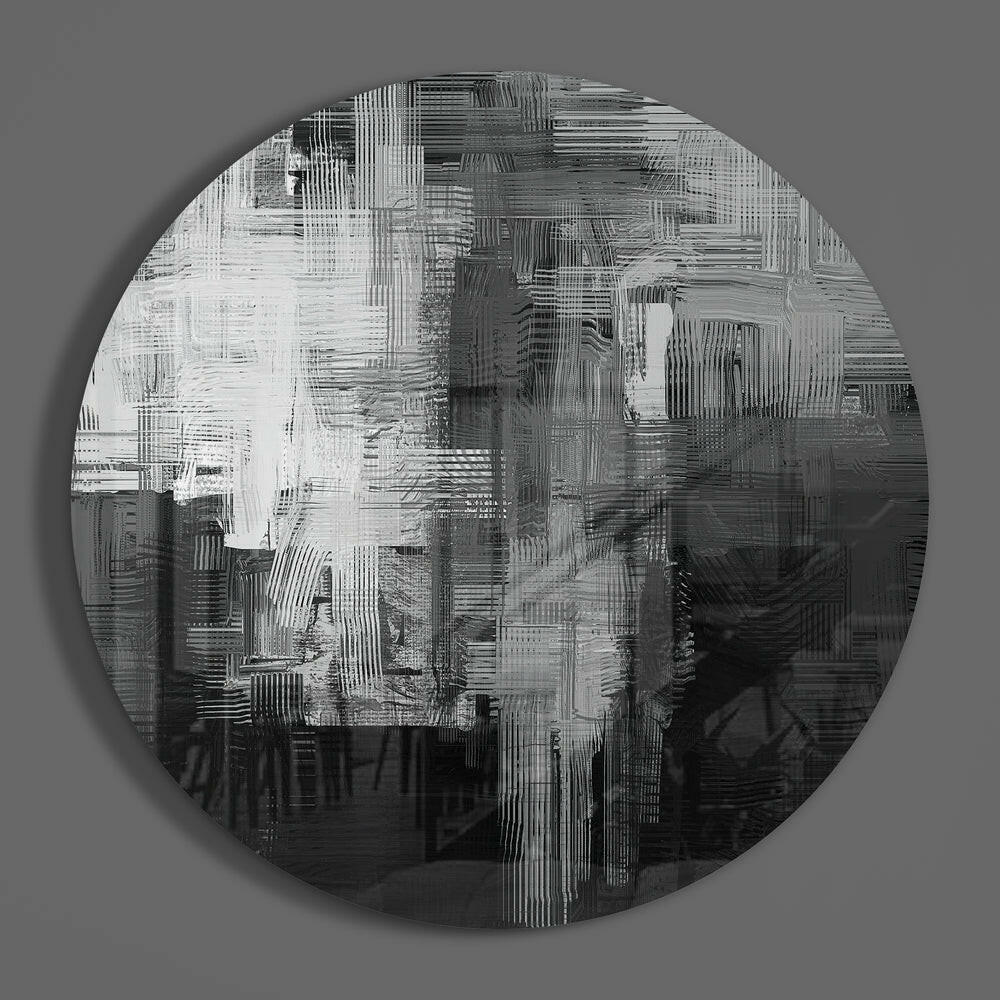 Black and white brushstroke round glass wall art hanging on a plain gray wall