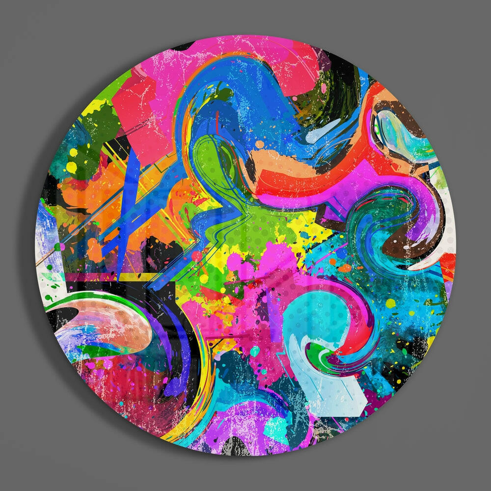 Colorful abstract swirls round glass wall art hanging on a plain gray wall