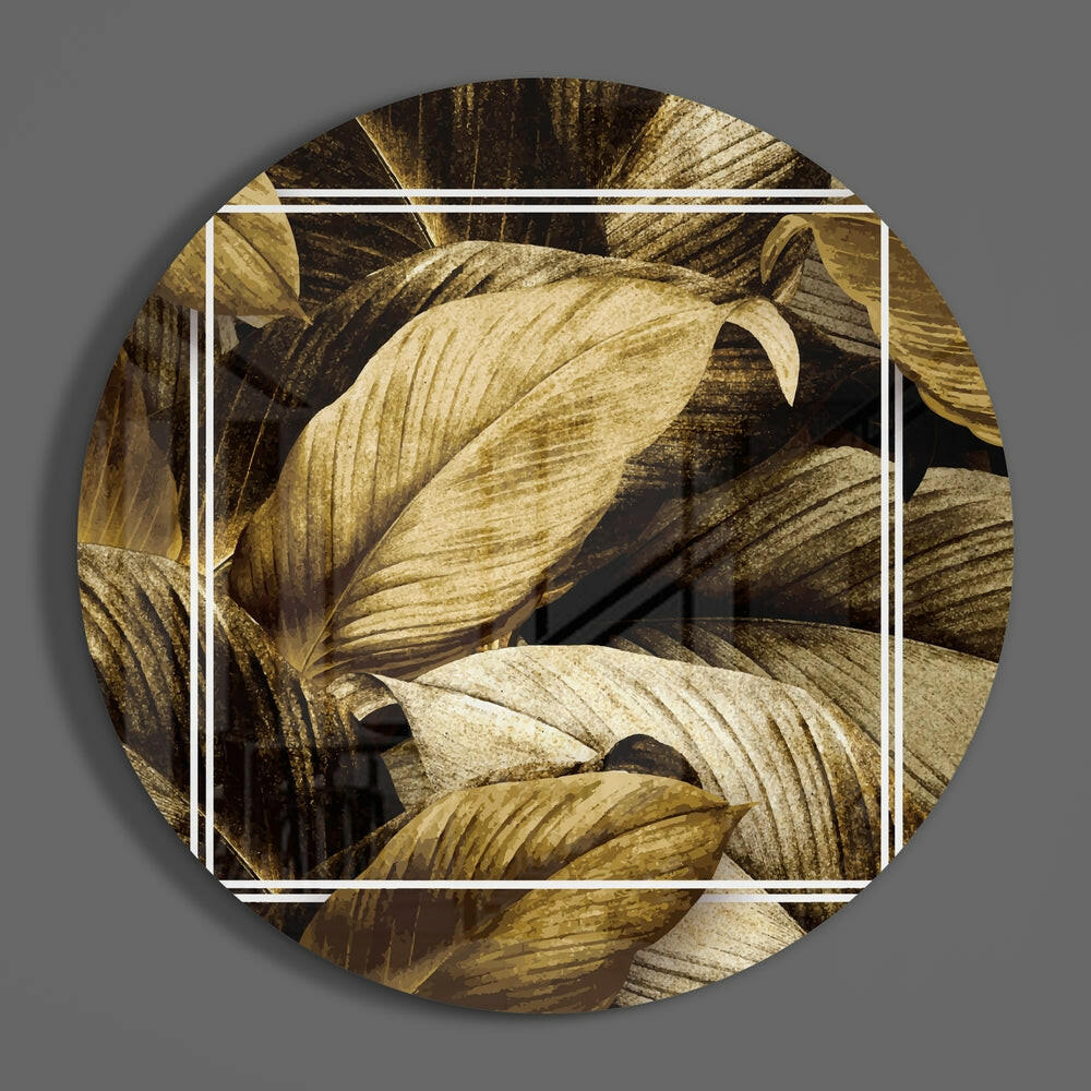 Golden sepia leaves round glass disc casting a soft shadow on a gray wall