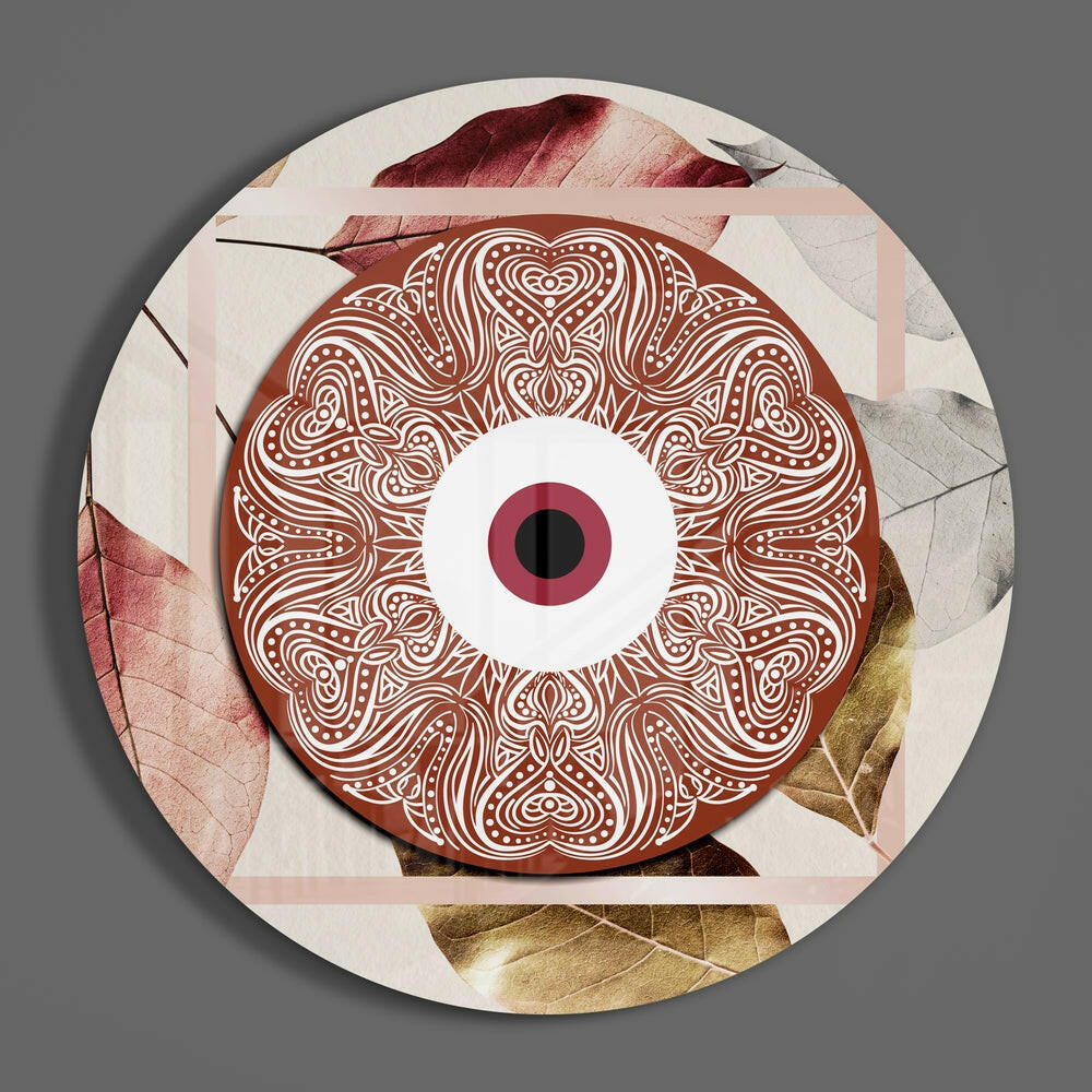 Terracotta mandala eye on leaves round glass wall art hanging on a plain gray wall