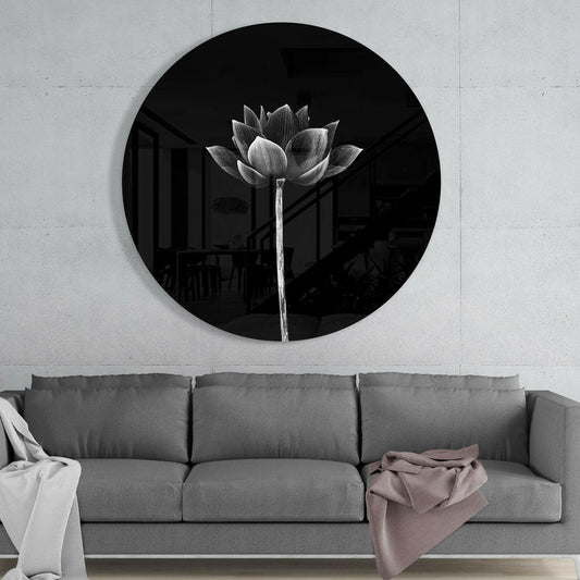 Monochrome lotus round glass wall art above a gray sofa with white and pink throws