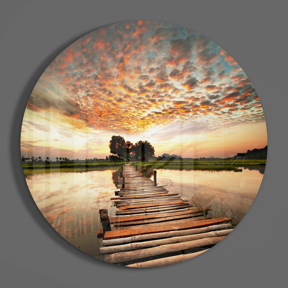 Wooden pier lake sunset round glass wall art on a plain gray wall