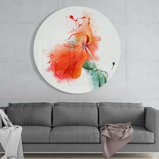 Orange poppy round glass wall art above a gray sofa with a draped throw on a pale concrete wall