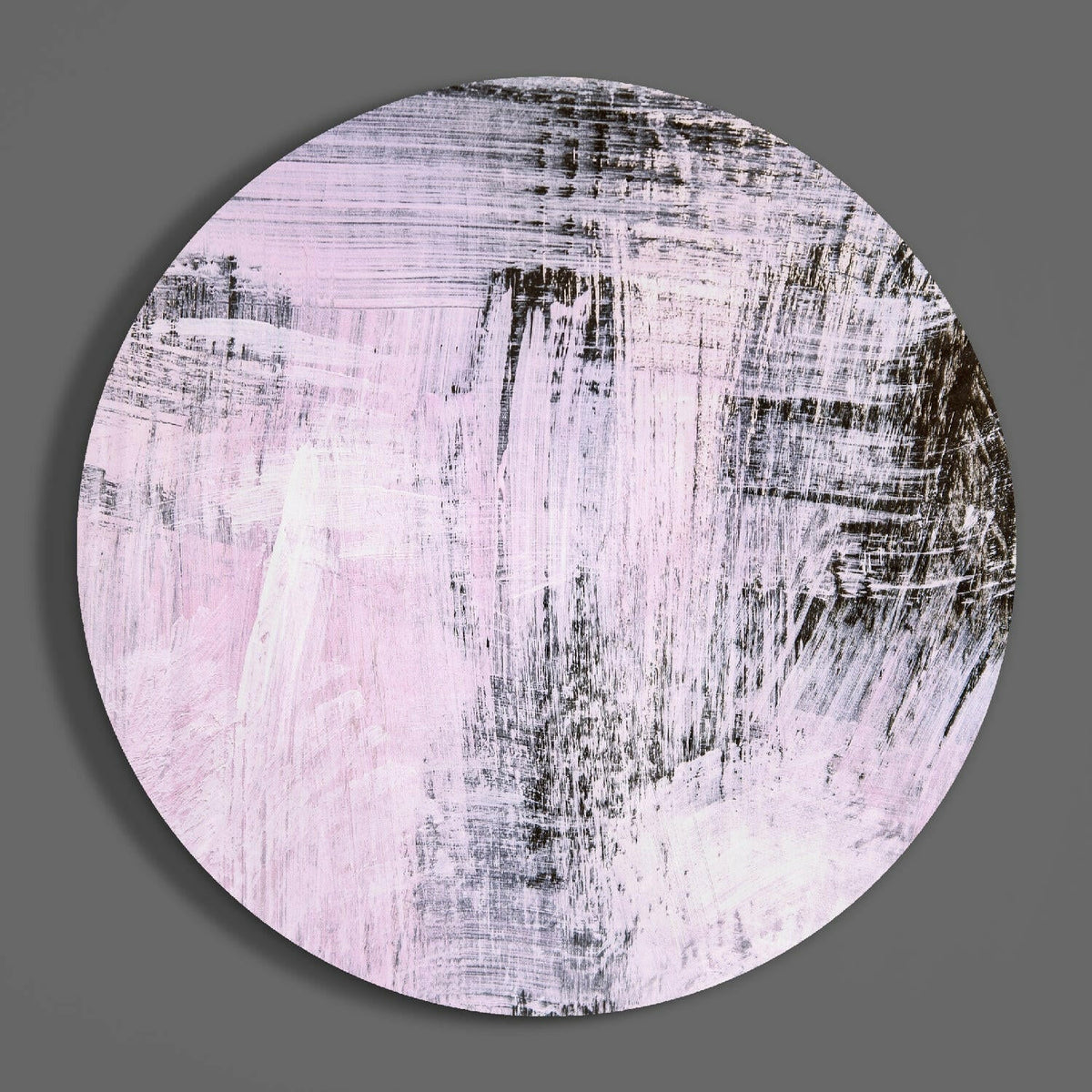 Lilac dry brush abstract round glass wall art on a plain gray wall, glossy glass disc seen from the front