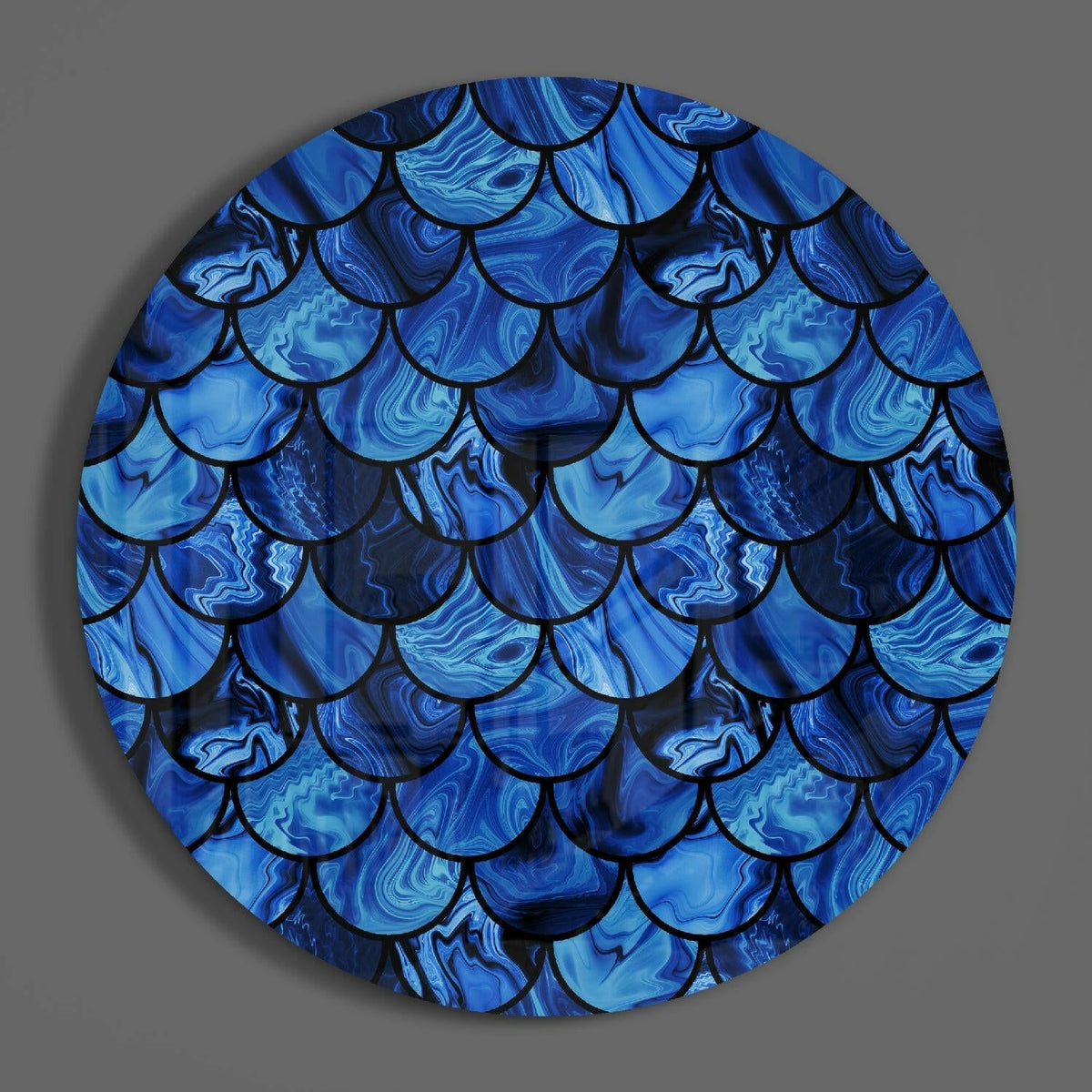 Blue mermaid scales round glass wall art on a plain gray wall