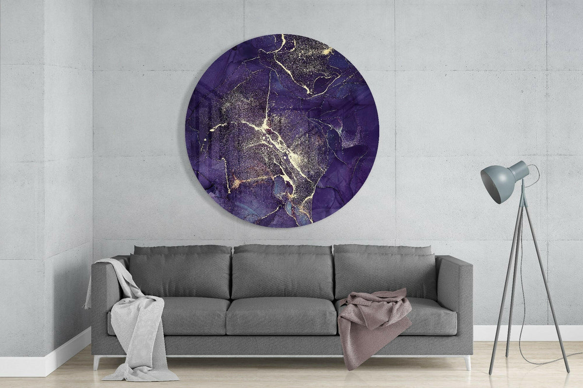 Purple and gold marble round glass wall art above a gray sofa with a tripod floor lamp