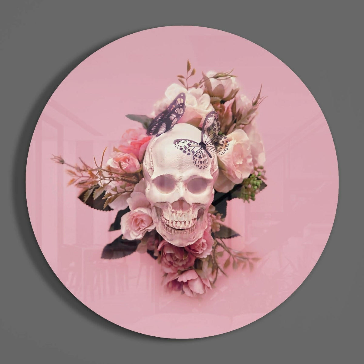 Blush rose skull round glass wall art hanging on a plain gray wall