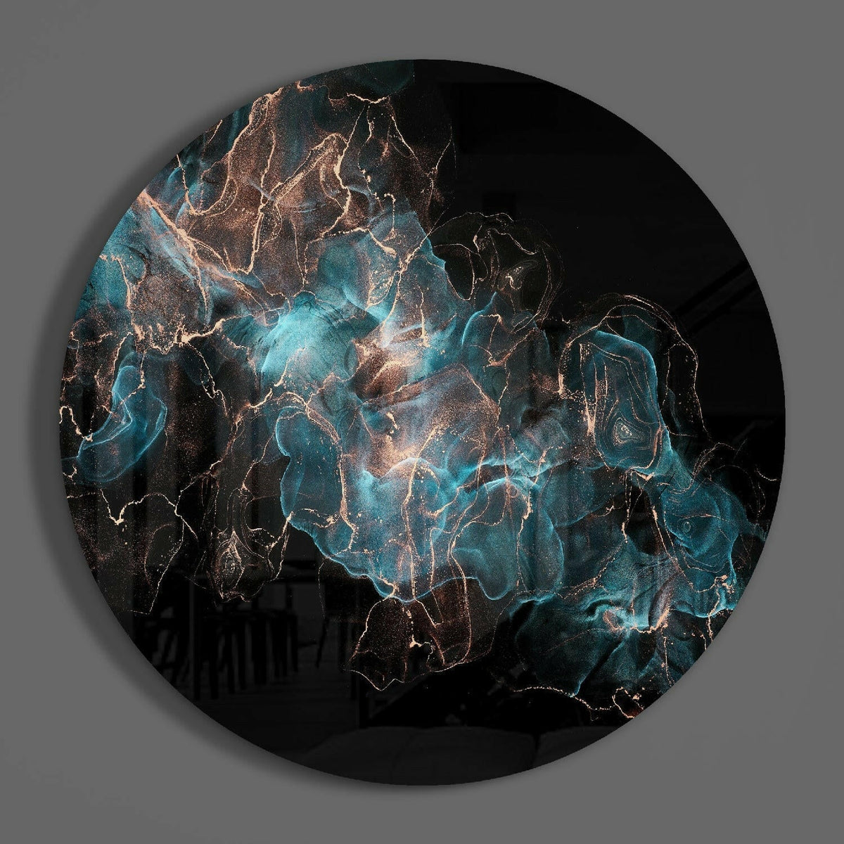 Teal and copper smoke round glass wall art on a plain gray wall