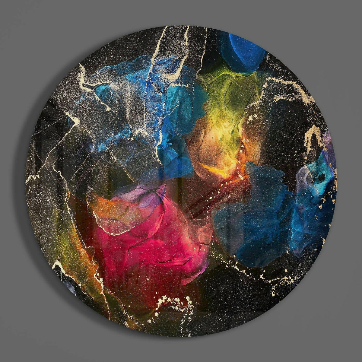 Jewel tone ink bloom round glass wall art on a plain gray wall, glossy glass disc seen from the front
