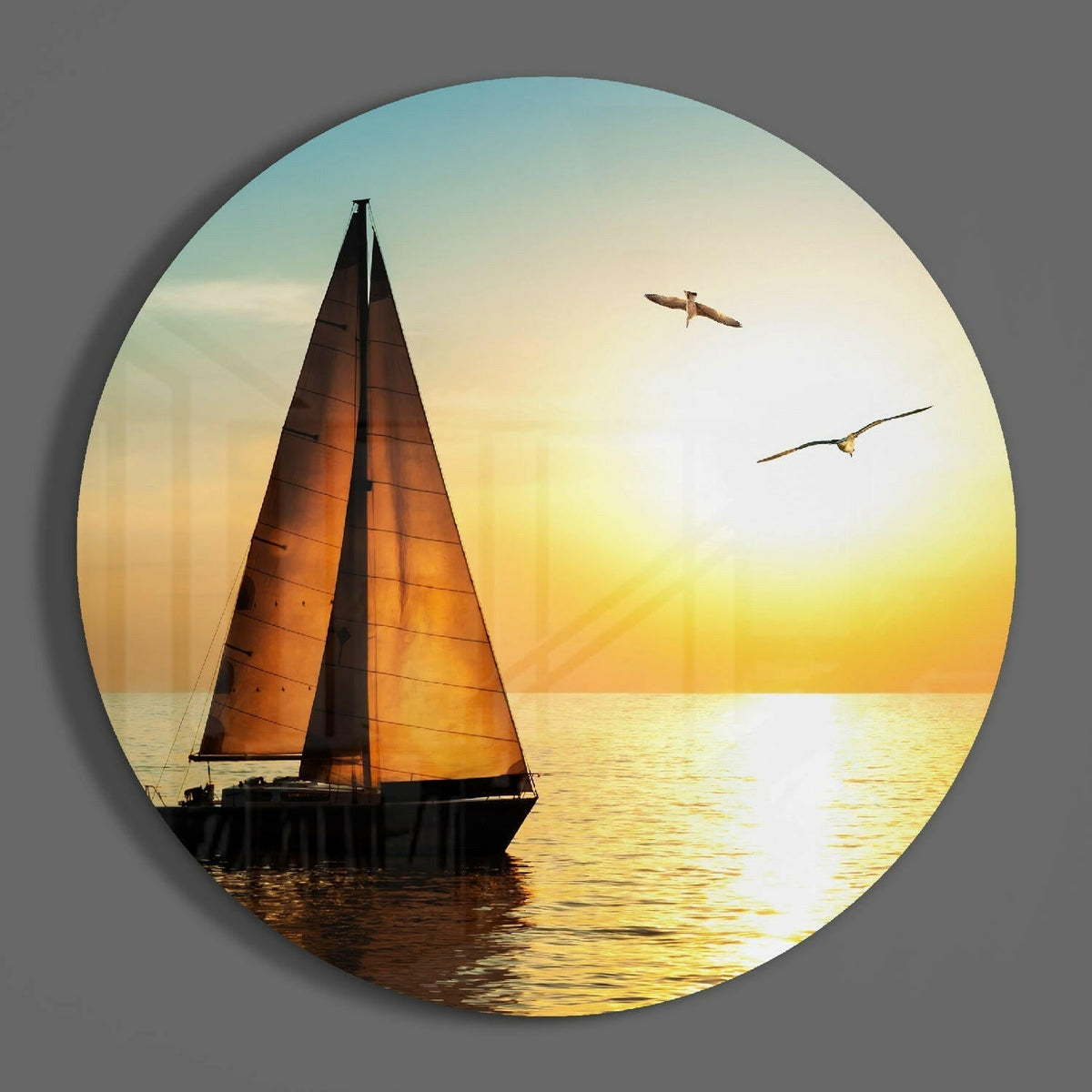 Sailboat at sunset circle of glass on a plain gray wall