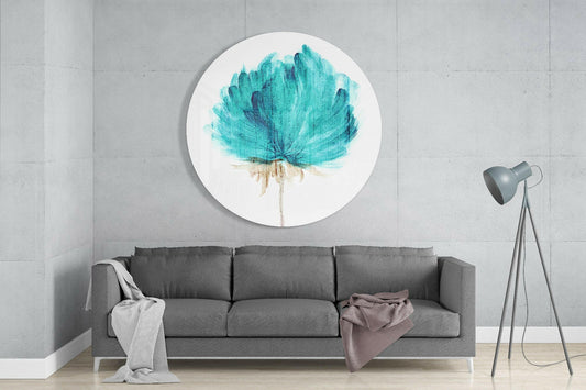 Teal flower round glass wall art above a gray sofa with a pink throw and a floor lamp