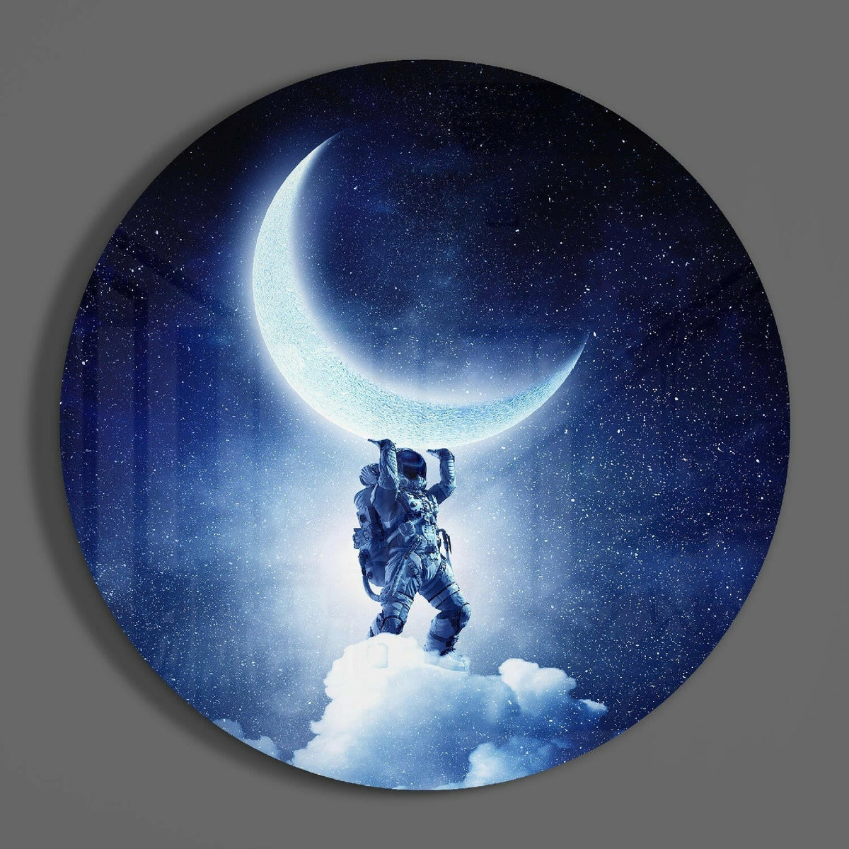 Astronaut lifting the moon round glass piece shown on a plain gray wall