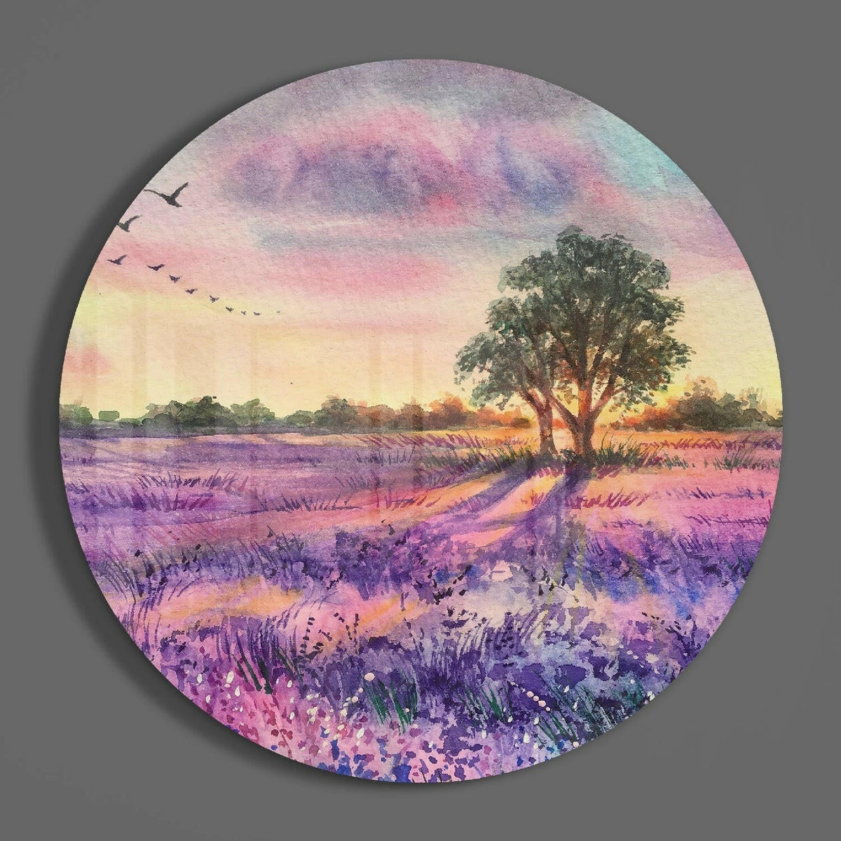 Watercolor lavender field and tree round glass wall art hanging on a plain gray wall