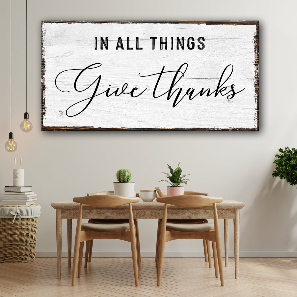 Give Thanks script canvas sign in the white plank-look style above a wood table with potted plants