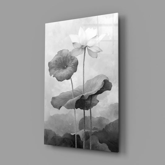 Black and white lotus glass wall art on a gray wall, light reflecting off the glossy front