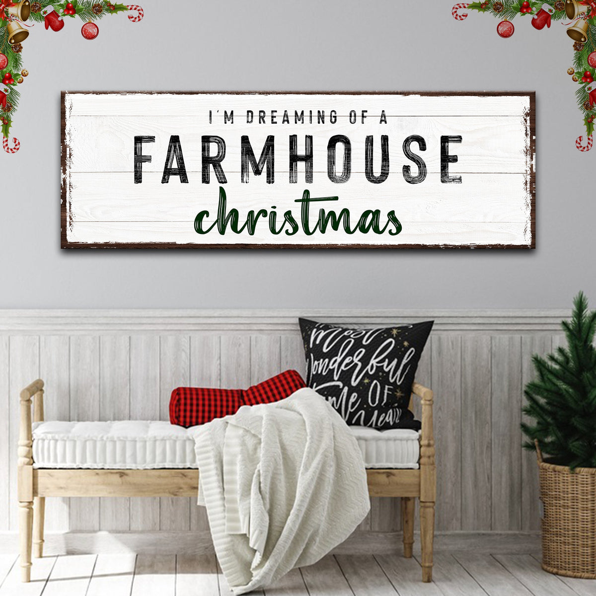 Style 2 of the Farmhouse Christmas canvas sign with green script and a brown edge, above a bench with a throw