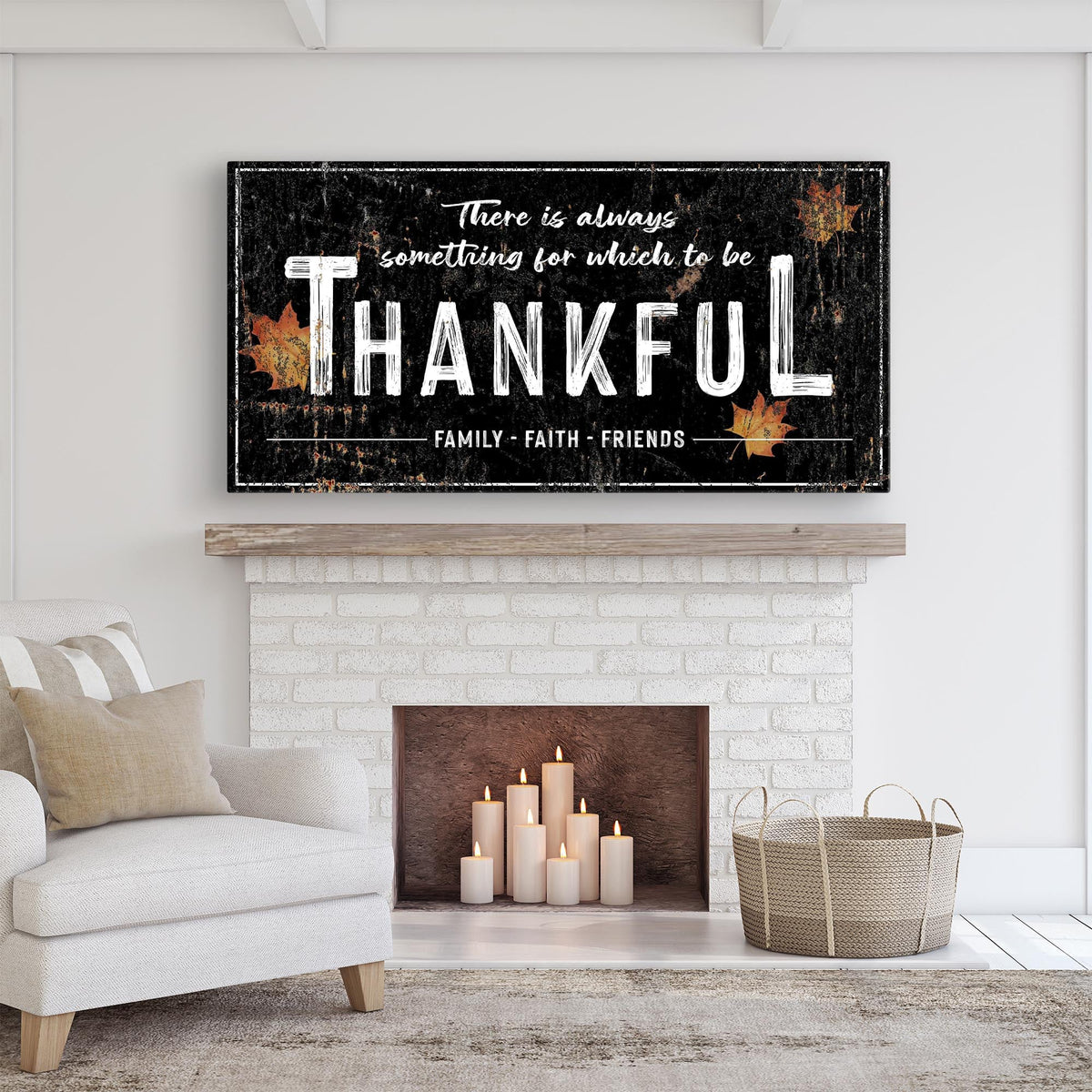 Thankful maple leaf canvas sign in the black style with white lettering above a white brick fireplace with candles