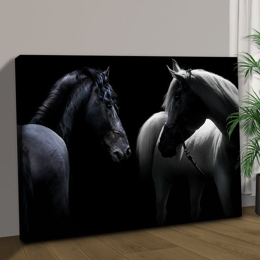 Black and White Horse Pair canvas leaning against a wall on a wood floor, angled close-up